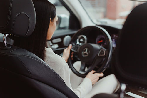 Woman driving a Mercedes