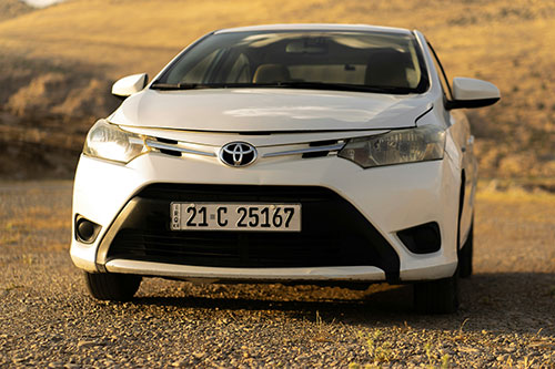 Toyota Yaris in white parked