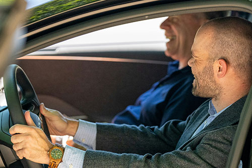 Man driving a car with a passenger