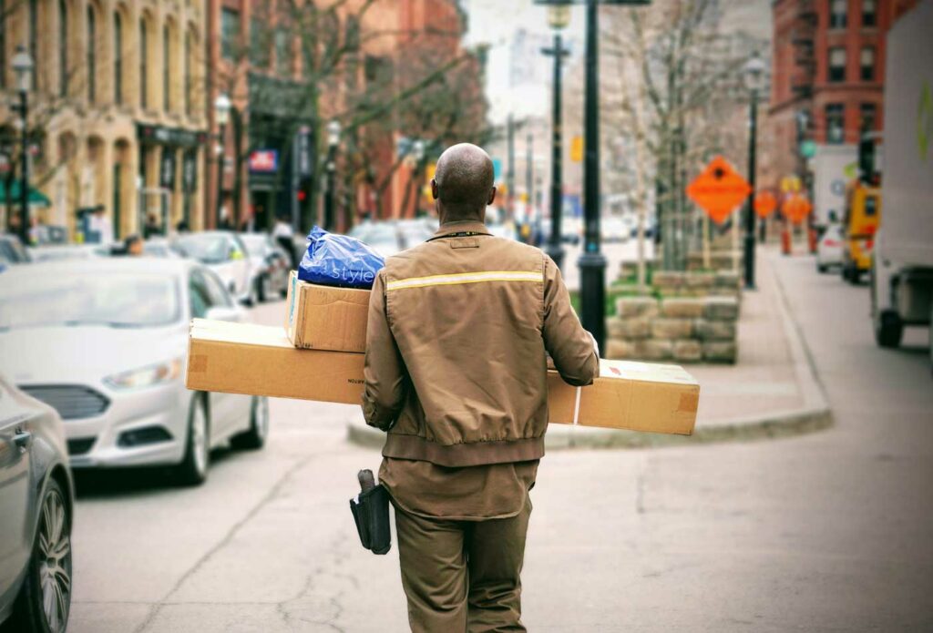shows an image of a courier delivering parcels - how to start a transport business in the UK