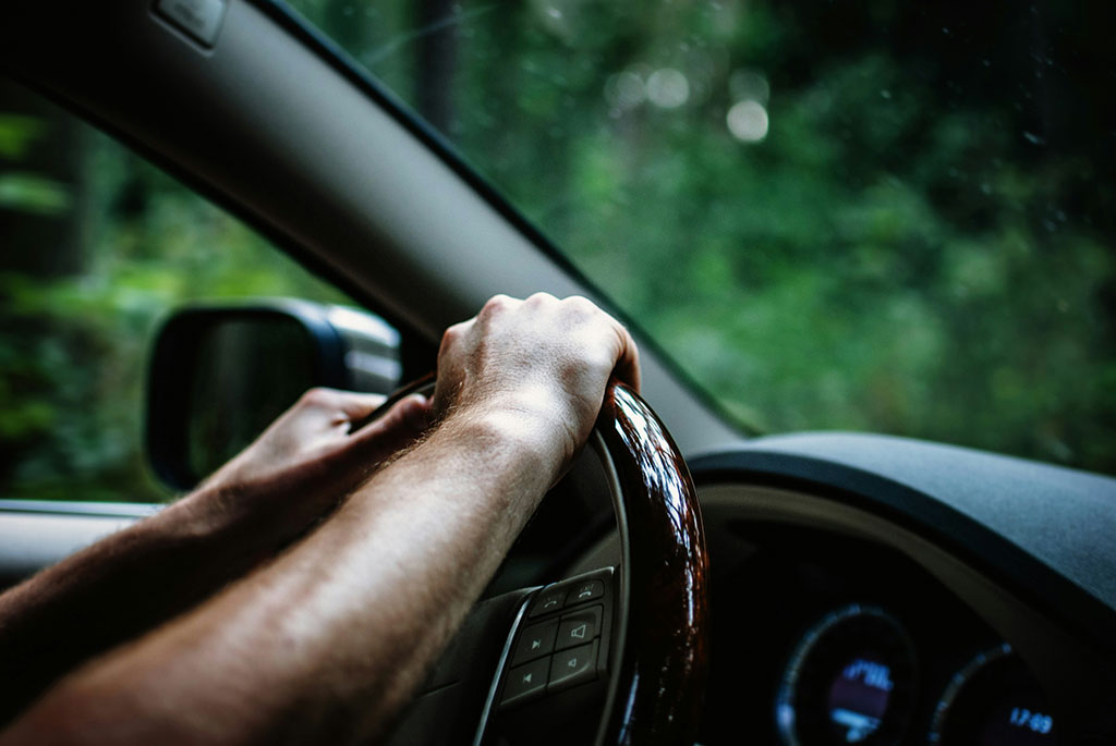 Man holding a steering wheel