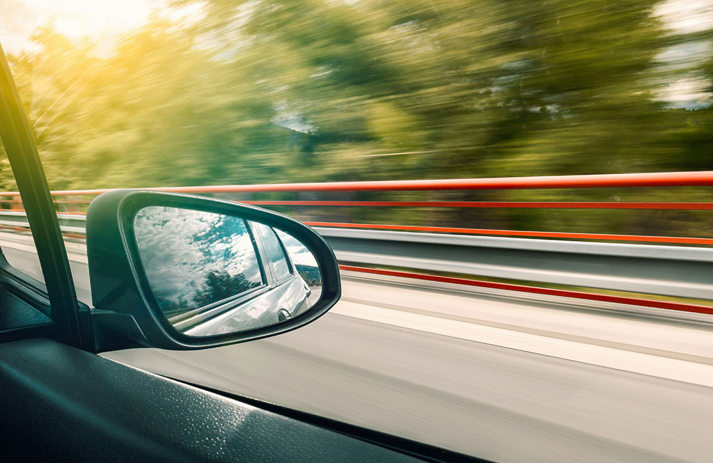 Speeding car looking at door mirror