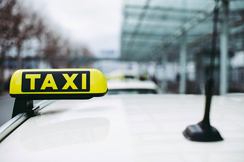 Taxi sign on top of car