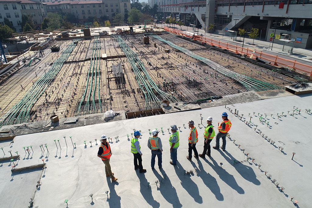 Men in hard hats looking over a building site