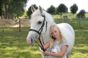 Horse rider insurance UK - Shows a child with her horse