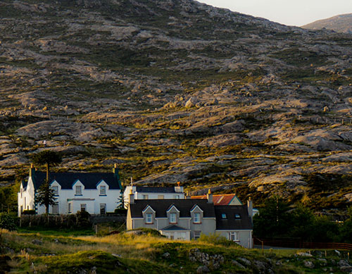 Two houses on a rocky hillside