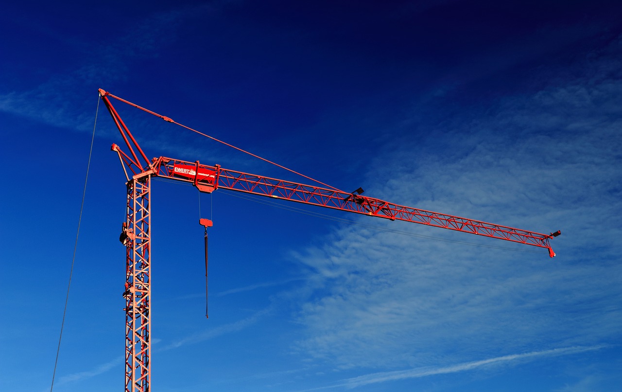 Crane Insurance - Shows a red crane on a construction site