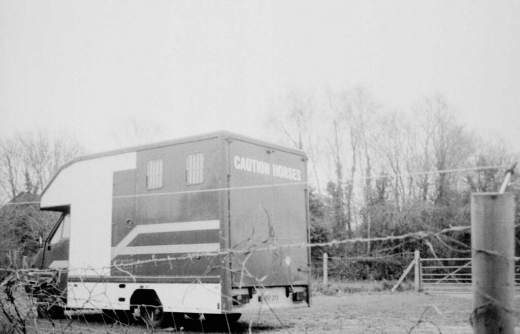 shows a black and white photo of a horse trailer - horse box insurance