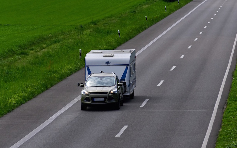 Caravan insurance guide - Shows a caravan being towed on a road