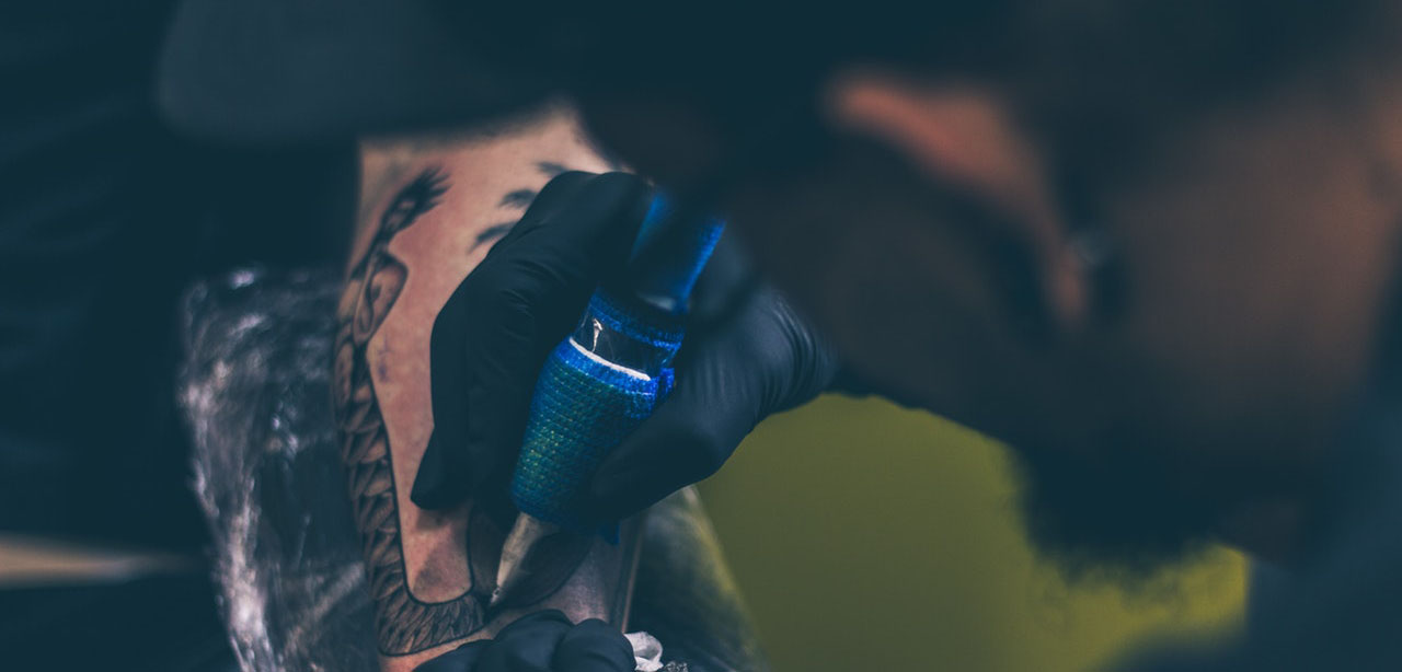 Tattoo Shop Insurance - Shows tattoo artist at work