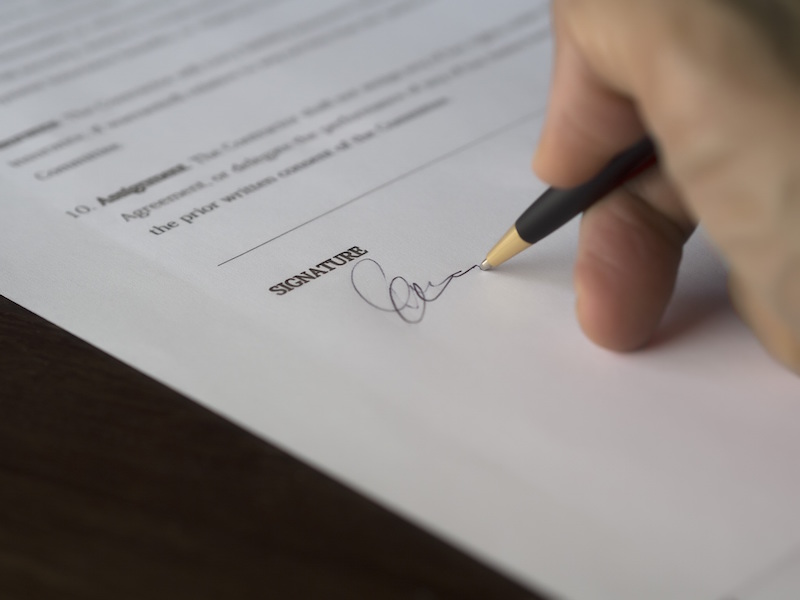 pension trustee signing paper