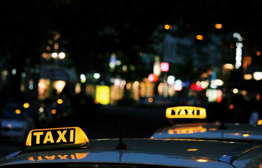 shows an image of two yellow taxi signs 