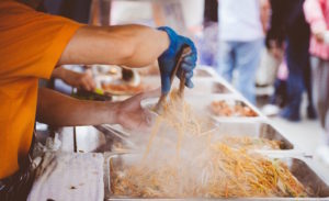 How to start a mobile catering business - Shows a person serving noodles