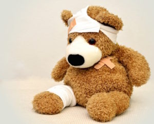 Shows an injured teddy bear