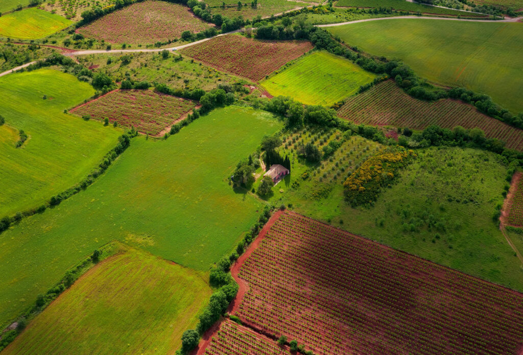 shows a birds eye view of farm land - Agricultural land insurance