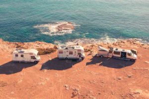 Mobile home insurance - Shows three mobile homes by a cliffside