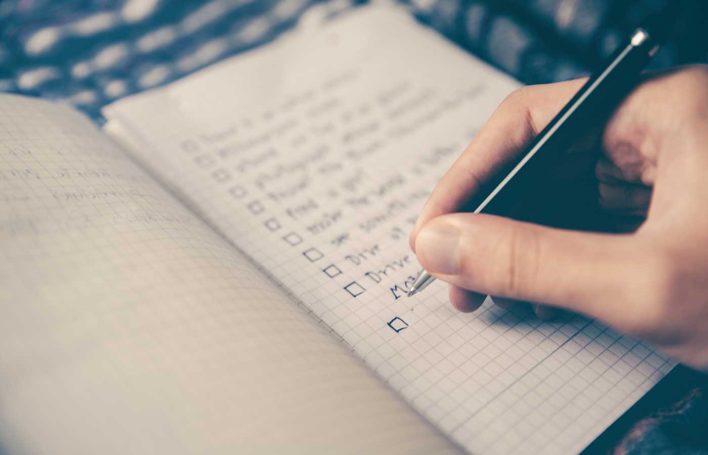 Organising a large event - Shows a person writing a checklist