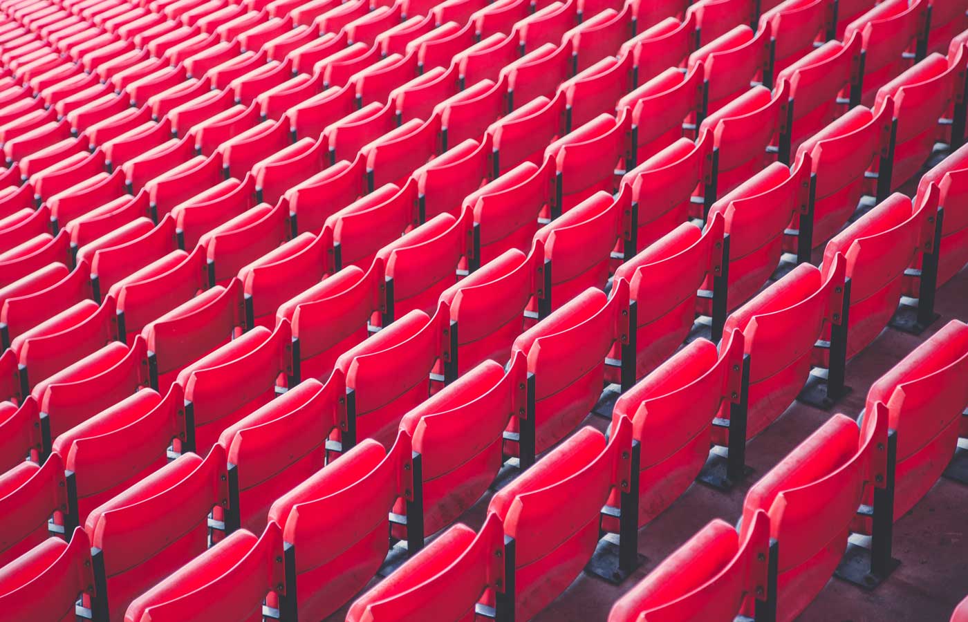 Empty red spectator chairs in a sports stadium