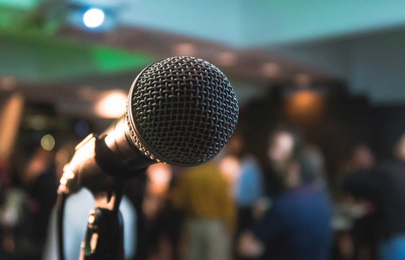 Shows a microphone at a corporate event