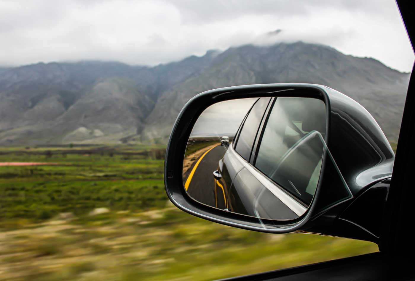 Driving school business insurance - Shows a side view mirror on a car