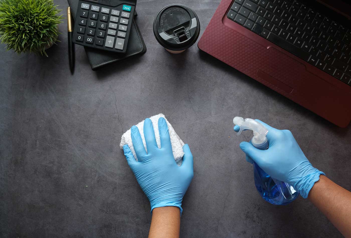 Cleaning business insurance - Shows a person cleaning a desk