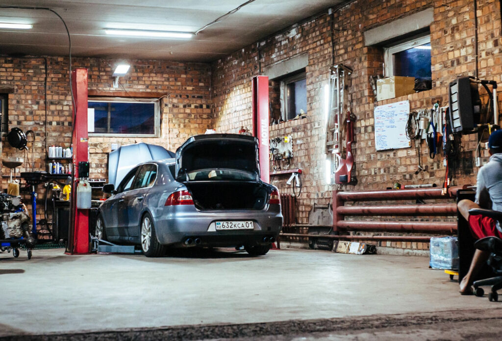 shows an image of a car being repaired in a garage