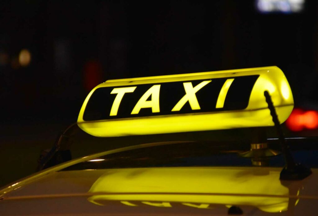 shows an image of a taxi sign - how to start a transport business in the UK