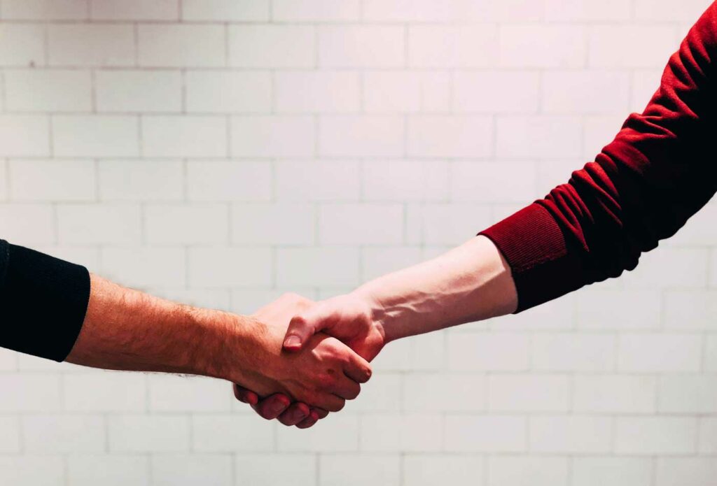 shows an image of two people shaking hands