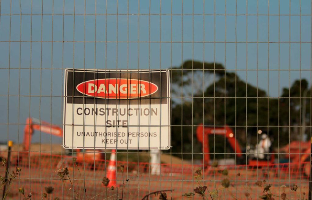 shows a danger sign in front of a construction site - construction site safety guide