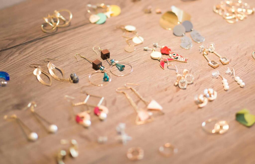 shows handmade earrings on a wooden table 