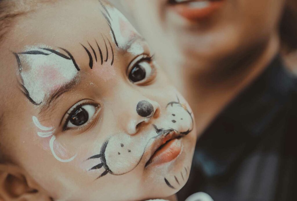 shows a girl with cat face paint - face painting insurance