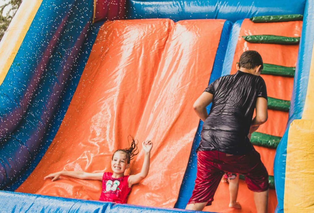 shows a girl playing on an inflatable slide - inflatable play equipment insurance