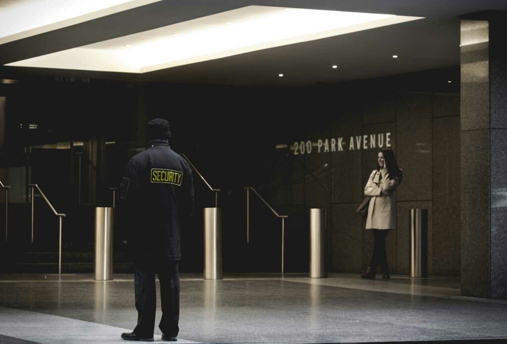 shows a security guard outside an office building - security insurance