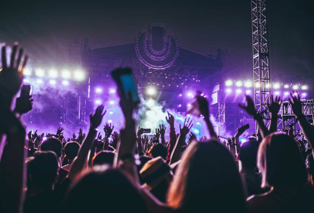 shows people dancing at a music concert - festival insurance