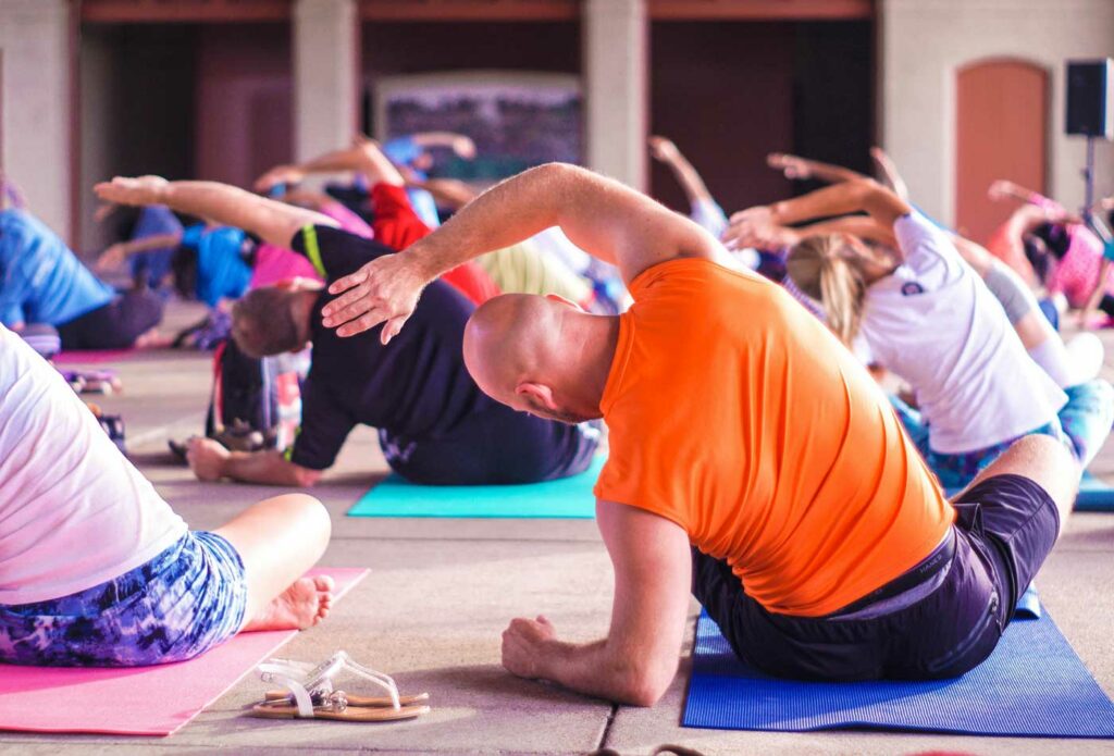 shows people practicing yoga - yoga teacher insurance