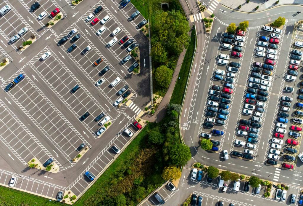 shows a birds eye view of cars in a parking lot 