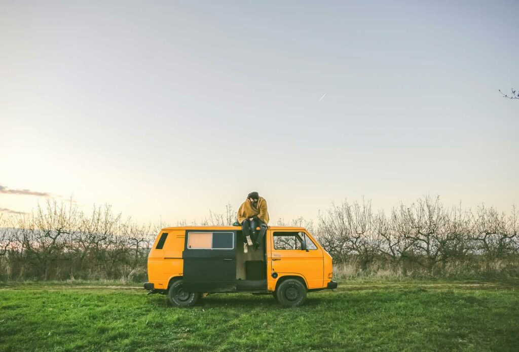 shows someone sitting on top of a campervan - campervan insurance