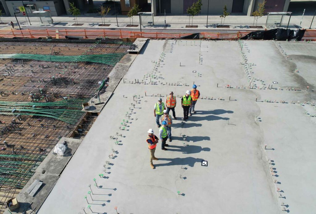 shows construction workers on top of a roof 