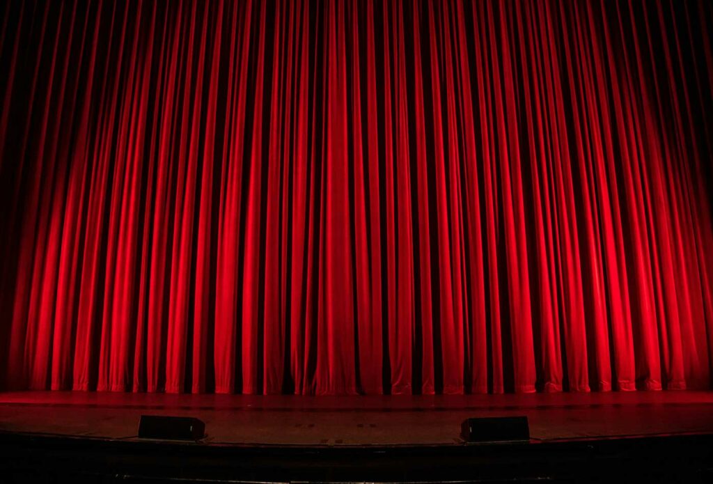 shows a red theatre curtain - performing arts insurance