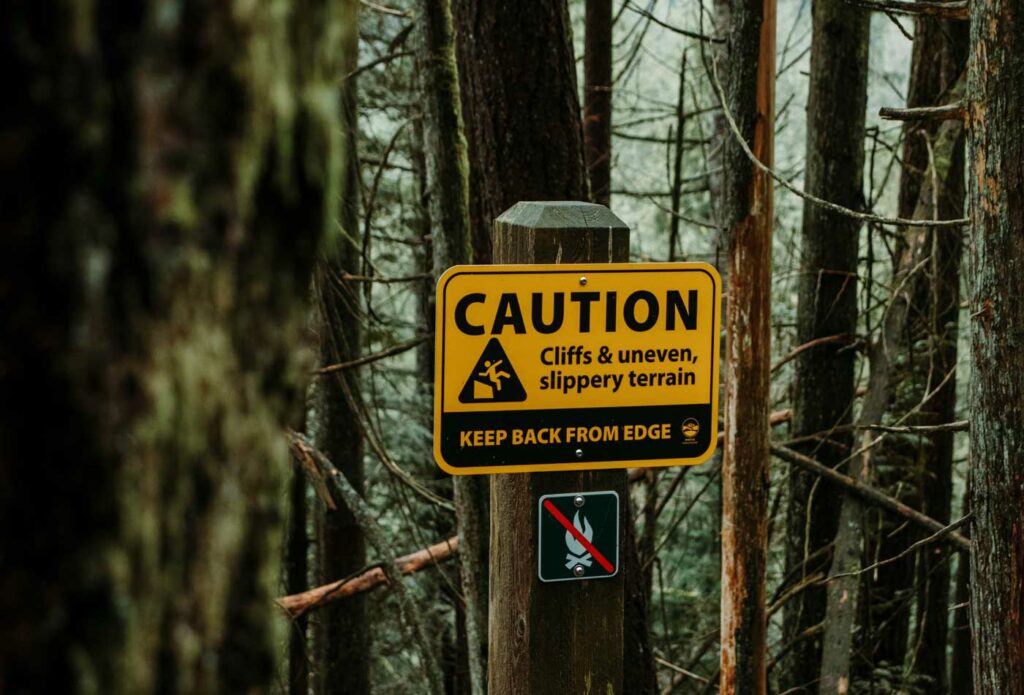 Shows a caution sign in a forest