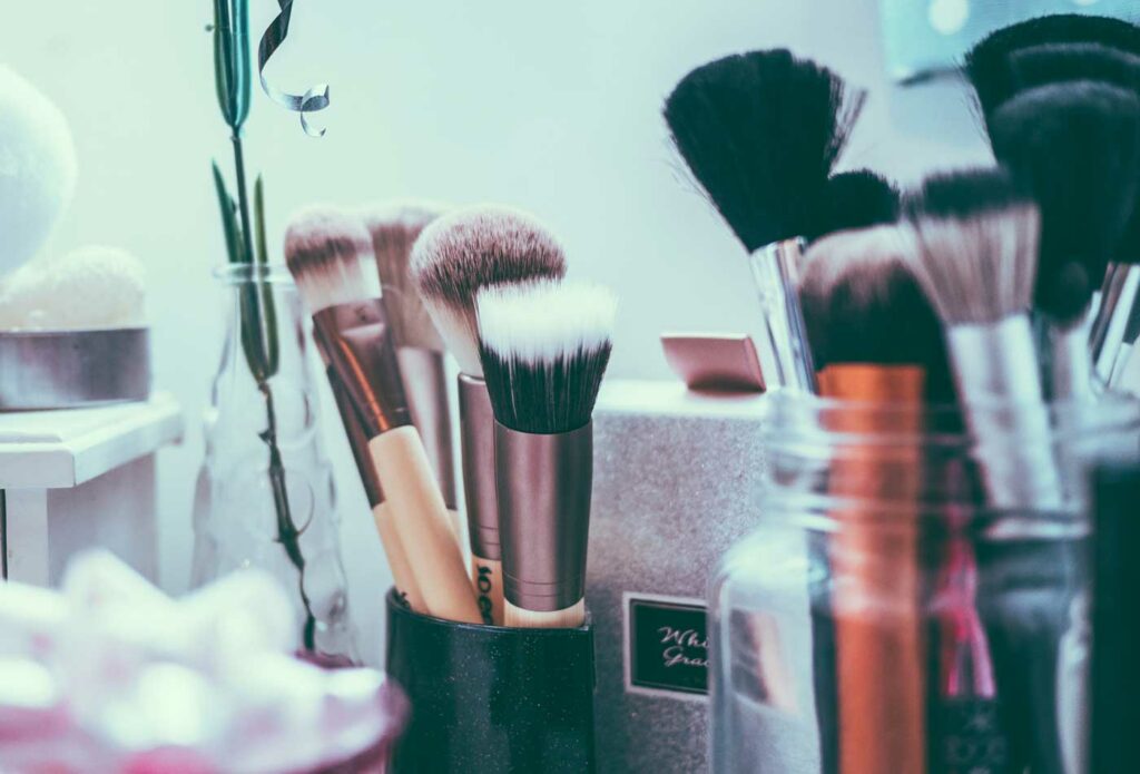 shows a close up of makeup brushes in a pot - makeup artist insurance